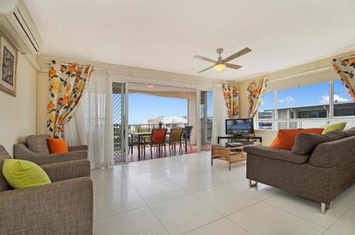 a living room filled with furniture and a window at The Beach Houses in Maroochydore