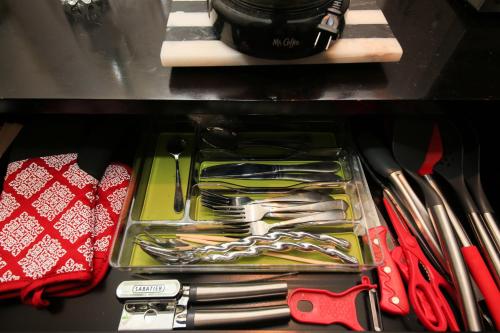 a drawer filled with lots of utensils on a table at Overlooking Marina del Rey sailboats, is Green Ginger Playa Del Rey on the bluff, in Los Angeles