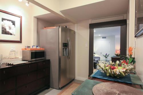 a kitchen with a stainless steel refrigerator and a microwave at Overlooking Marina del Rey sailboats, is Green Ginger Playa Del Rey on the bluff, in Los Angeles