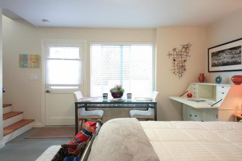 a bedroom with a desk and a table with chairs at Overlooking Marina del Rey sailboats, is Green Ginger Playa Del Rey on the bluff, in Los Angeles