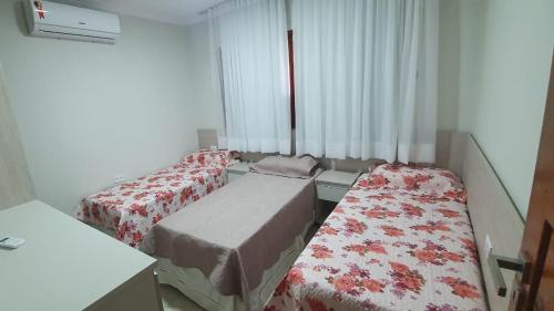 Giường trong phòng chung tại Casa Darci - Beira-mar, no Condomínio Village