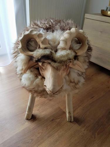 a stuffed animalanimal with legs on a wooden floor at Galeria Apartments - Jasná in Demanovska Dolina
