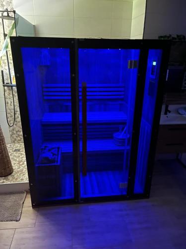 a glass cabinet with blue lights inside of it at Vitospa in Cauffry