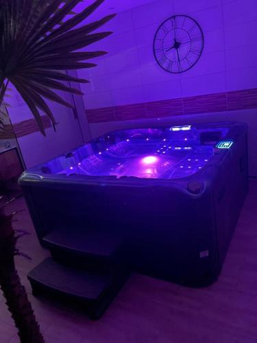 jacuzzi con luces púrpuras en una habitación en Vitospa, en Cauffry