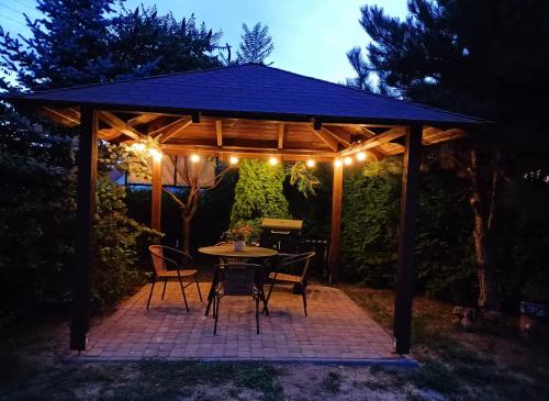 a gazebo with a table and chairs and lights at PAKLADA 3 Pokój typu studio in Karsin