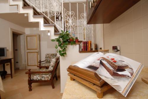 a room with a table with bread and a staircase at Antica Dimora delle Acque in Cannara