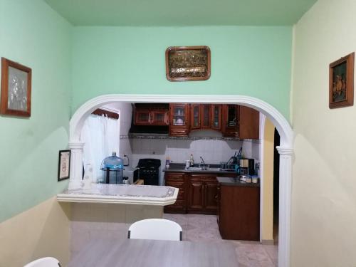 a kitchen with an archway in the middle of a room at Huasteco, tu casa en valles! in Ciudad Valles