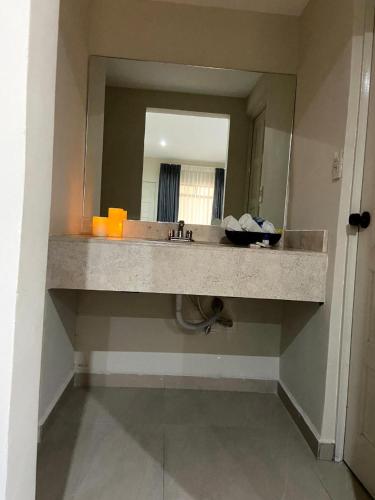 a bathroom counter with a sink and a mirror at HOTEL LOS ROBLES in Nuevo Laredo