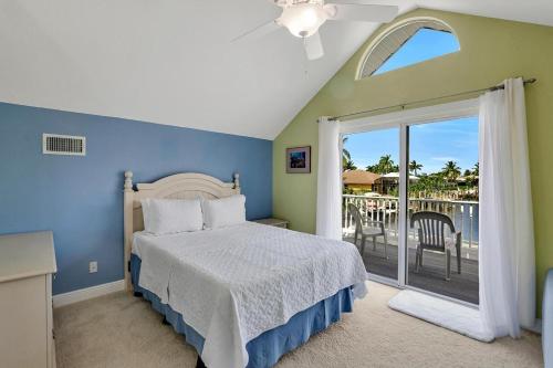 a bedroom with a bed and a balcony at Waterfront home with pool and foosball table in Marco Island