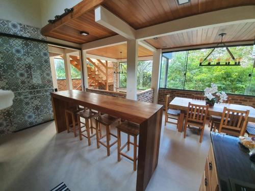 a dining room with a large wooden table and chairs at ATLANTIC FOREST HOUSE AT FOREST in Angra dos Reis