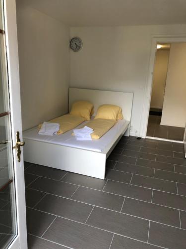 a bed in a room with a clock on the wall at Villa Matten in Matten