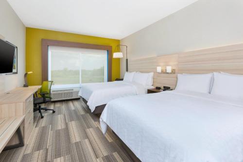 a hotel room with two beds and a flat screen tv at Holiday Inn Express & Suites - Grand Rapids Airport - South by IHG in Grand Rapids