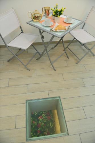 a table with two chairs and a plate of food on it at Bed and Breakfast Oz in Bari