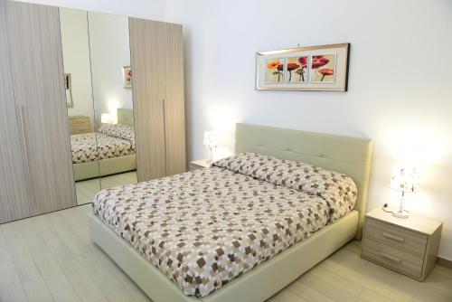 a bedroom with a bed and a mirror at Bed and Breakfast Oz in Bari