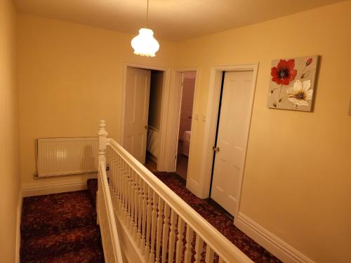 a hallway with a stairway leading to a bedroom at Vetrelax Ipswich Woodbridge Apartment in Ipswich