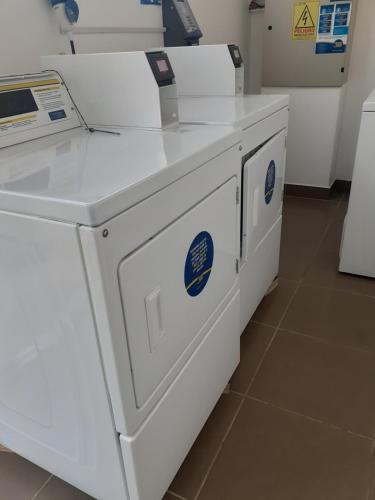 a white washing machine sitting on top of a counter at Esmeralda Apartment in El Tabo