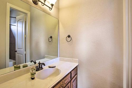a bathroom with a sink and a large mirror at 4 Mi to Grapevine Lake Texas Home with Media Room in Flower Mound