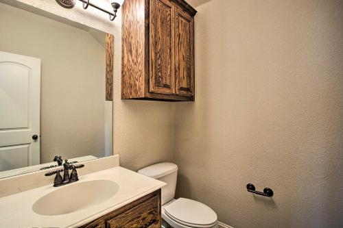 a bathroom with a sink and a toilet and a mirror at 4 Mi to Grapevine Lake Texas Home with Media Room in Flower Mound