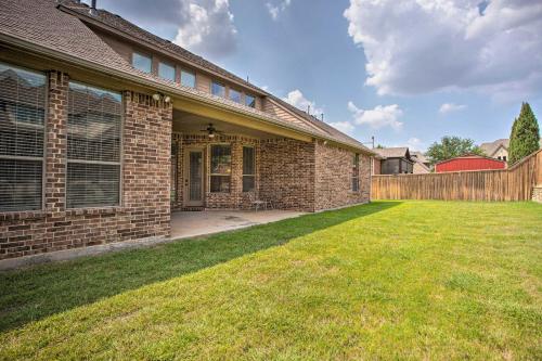 a brick house with a lawn in front of it at 4 Mi to Grapevine Lake Texas Home with Media Room in Flower Mound