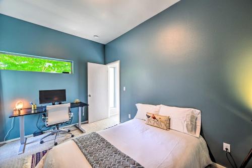 a bedroom with blue walls and a bed and a desk at Seattle Retreat with Canal and Mountain Rooftop Views! in Seattle