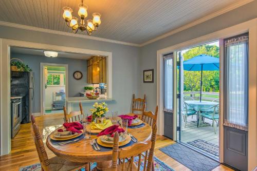 a dining room with a table and chairs and an open door at Restored Mars Hill Home on 1 Acre Walk to Town! in Mars Hill