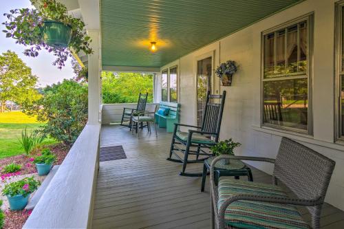 a front porch with chairs and a table at Restored Mars Hill Home on 1 Acre Walk to Town! in Mars Hill