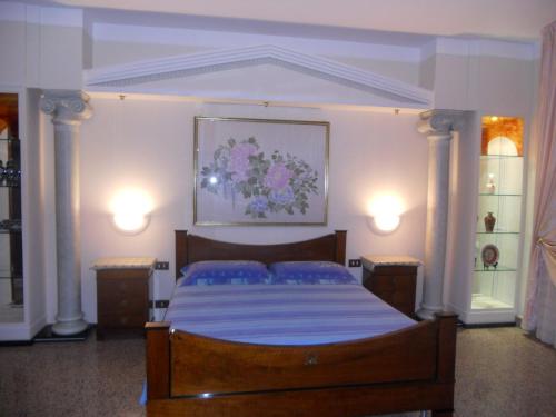 a bedroom with a large bed with blue pillows at Le Schiavelle in Surbo