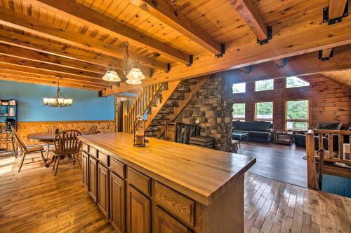 a kitchen and living room with a counter and a fireplace at Cozy Family-Friendly Pine Grove Cabin with Fire Pit! in Pine Grove