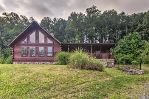 a log home with a large yard at Cozy Family-Friendly Pine Grove Cabin with Fire Pit! in Pine Grove