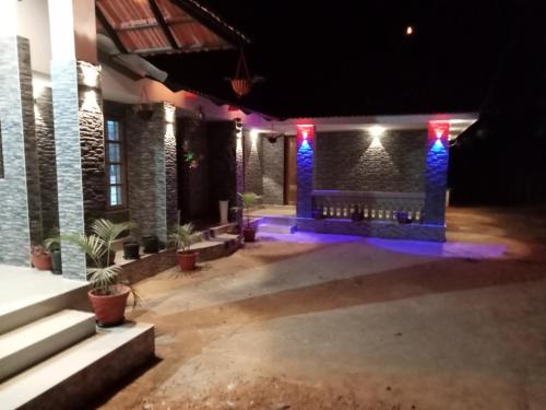 a dark room with a bench and blue lights at SanSree's Puzhakkal Homestay in Wayanad