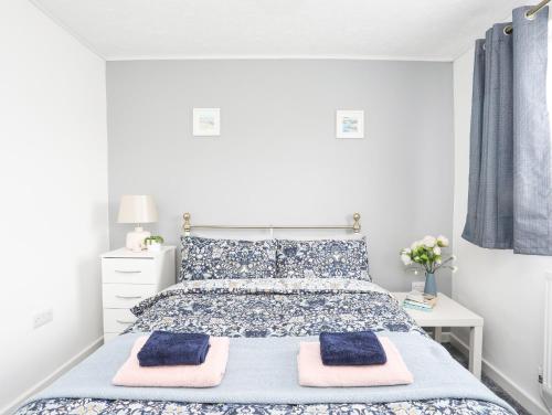 a bedroom with a bed with two towels on it at Garnedd Rhos in Brynteg