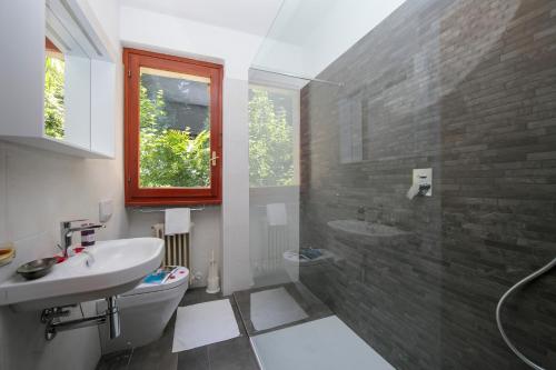 a bathroom with a sink and a toilet and a shower at Bella Menaggio Terrazzo in Menaggio