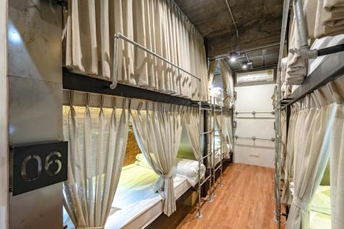 a group of bunk beds in a room at Siam Plug In Hostel in Bangkok