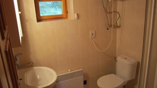 a small bathroom with a toilet and a sink at Bungalov Tina in Žiar