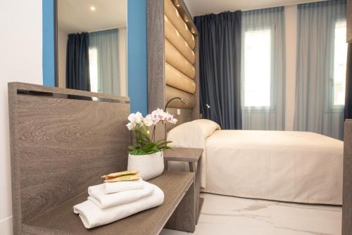 Säng eller sängar i ett rum på Hotel Marconi Express