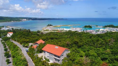 an aerial view of a city and the ocean at ホテルコンドミニアム土花土花 in Onna