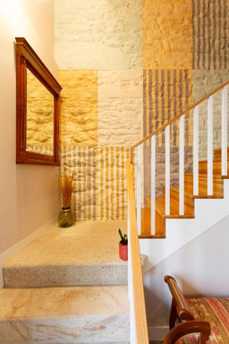 a staircase in a house with a window at Hotel Casa da Galbana in Friol
