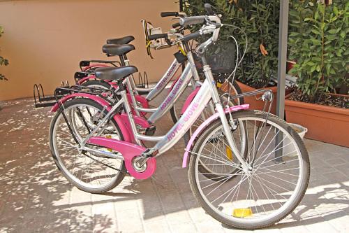 two pink bikes parked next to each other at Hotel Giove dipendenza Hotel Fiamma in Cesenatico