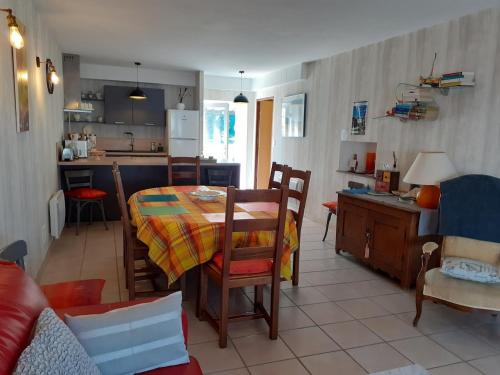 a kitchen and living room with a table and a kitchen and a dining room at Gîte Carnot in Dompaire