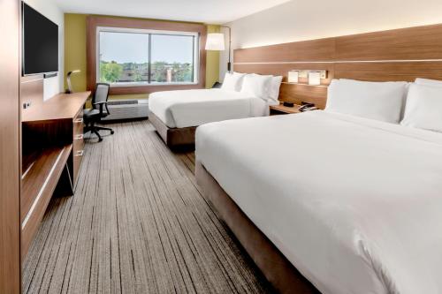 a hotel room with two beds and a television at Holiday Inn Express & Suites - Milwaukee West Allis by IHG in West Allis