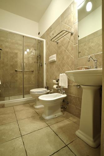 a bathroom with a toilet and a sink and a shower at Hotel Tenuta San Francesco in Barletta