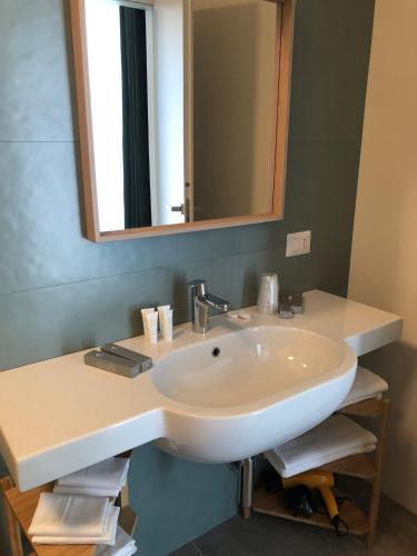 a bathroom with a white sink and a mirror at Verde Matematico in Vico del Gargano