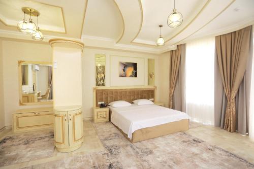 a bedroom with a bed and a large mirror at Reikartz Amirun Tashkent in Tashkent