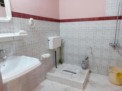 a bathroom with a toilet and a sink at Bhurban valley guest house in Murree