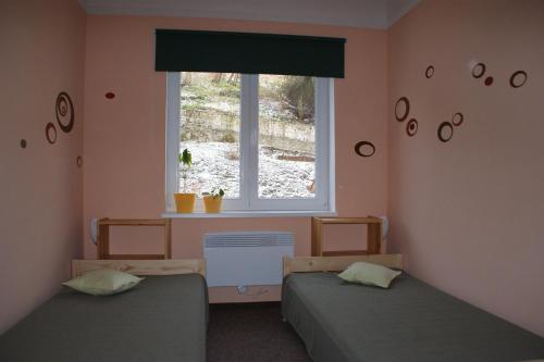 a bedroom with two beds and a window at Ubytování pod Jezem in Loket
