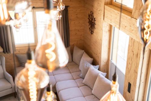 a living room with a white couch in a room at Quality Hosts Arlberg - ALPtyrol Appartements in Sankt Anton am Arlberg