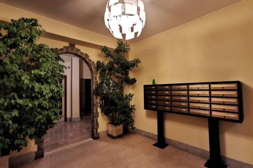 a hallway with plants and a chandelier in a building at Appartamento - IRIS - Vallecrosia in Vallecrosia