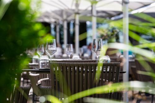 a row of wine glasses sitting on a table at See & Park Hotel Feldbach in Steckborn