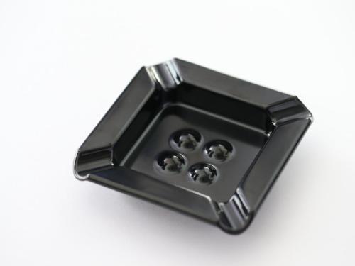 a black metal box with four knobs on a white background at APA Hotel Komatsu Grand in Komatsu
