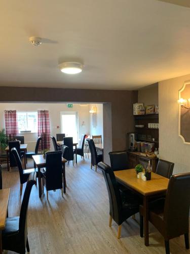 a dining room with tables and chairs at Hall Park Hotel self check in in Workington